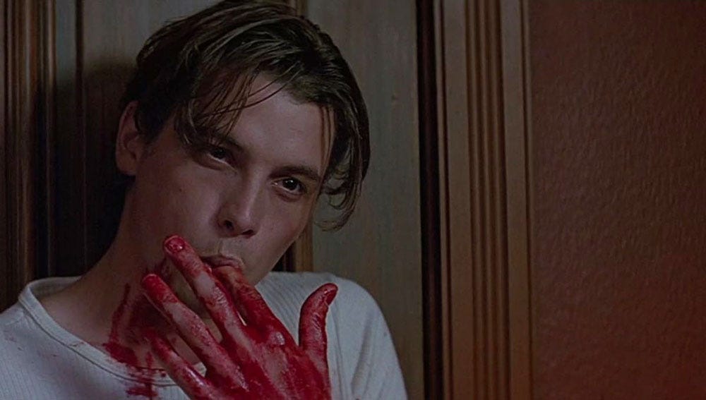 Skeet Ulrich as Billy Loomis in Scream (1996) licking fake blood from his finger