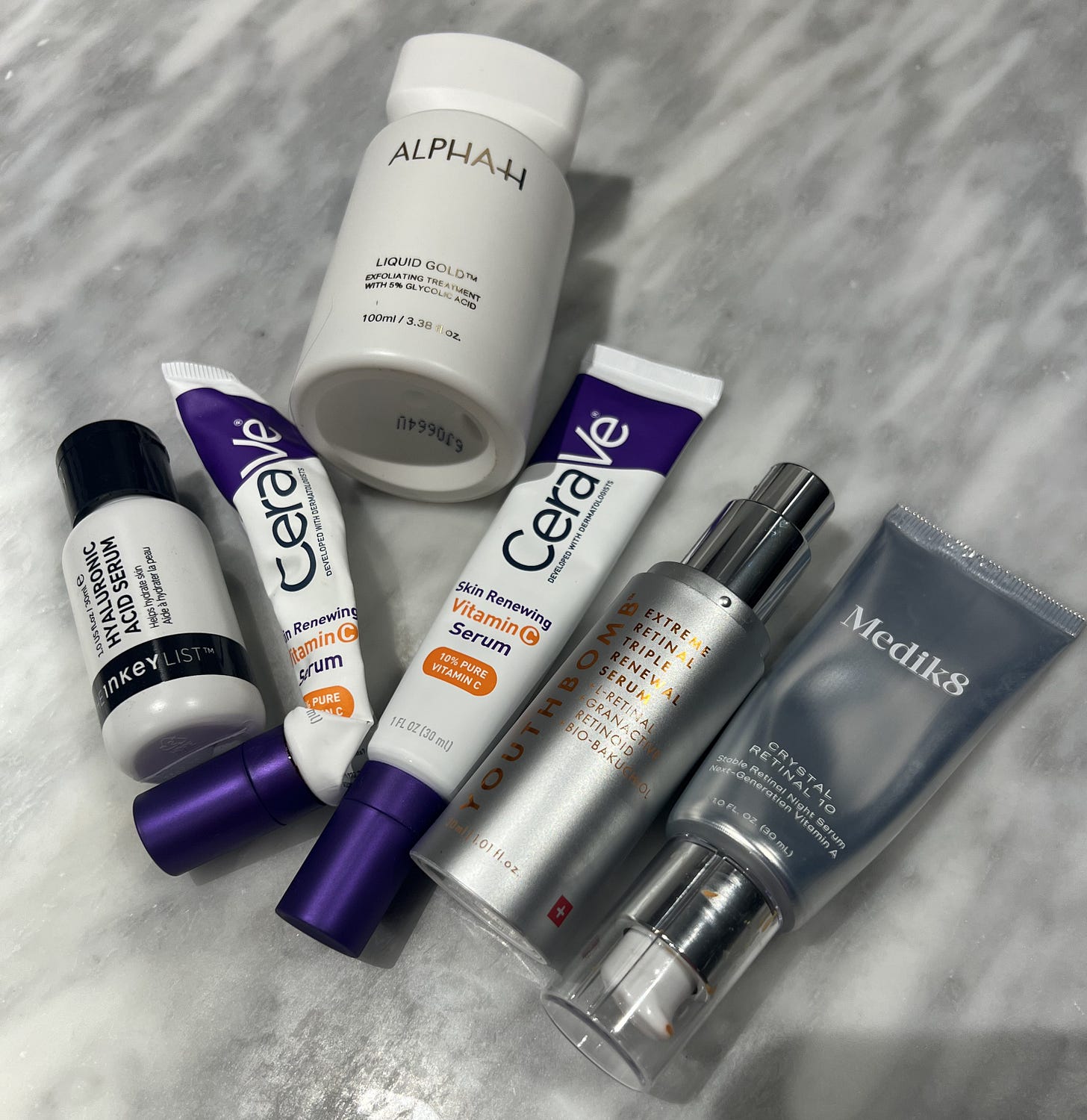 An image of midlife Beauty Editor Donna Franicis favourite active skincare products including Medik8 Retinal 10 Beauty Pie Retinal The Inkey List Hyaluronic Serum Alpha H The Liquid Gold Cerave Vitamin C Serum 