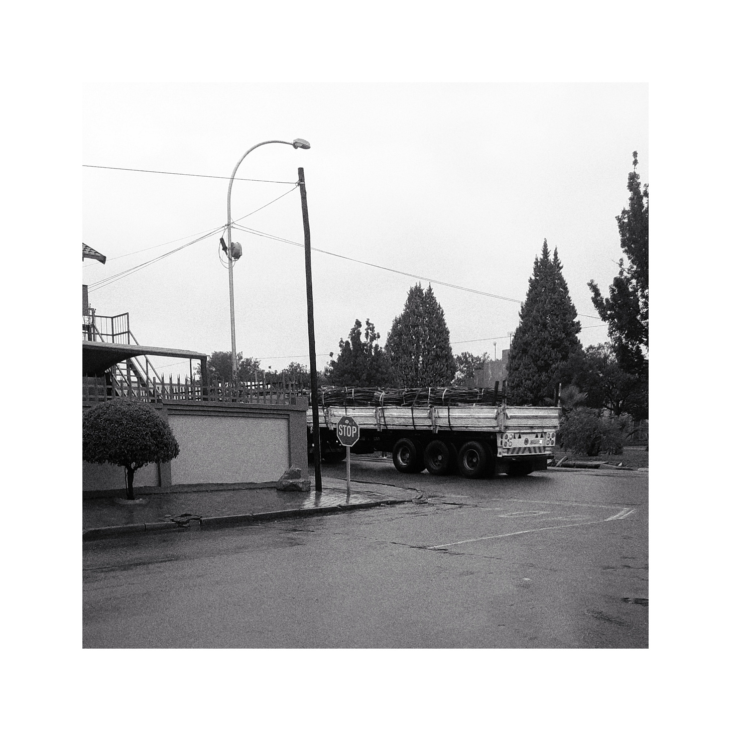 A truck passing a stop sign.
