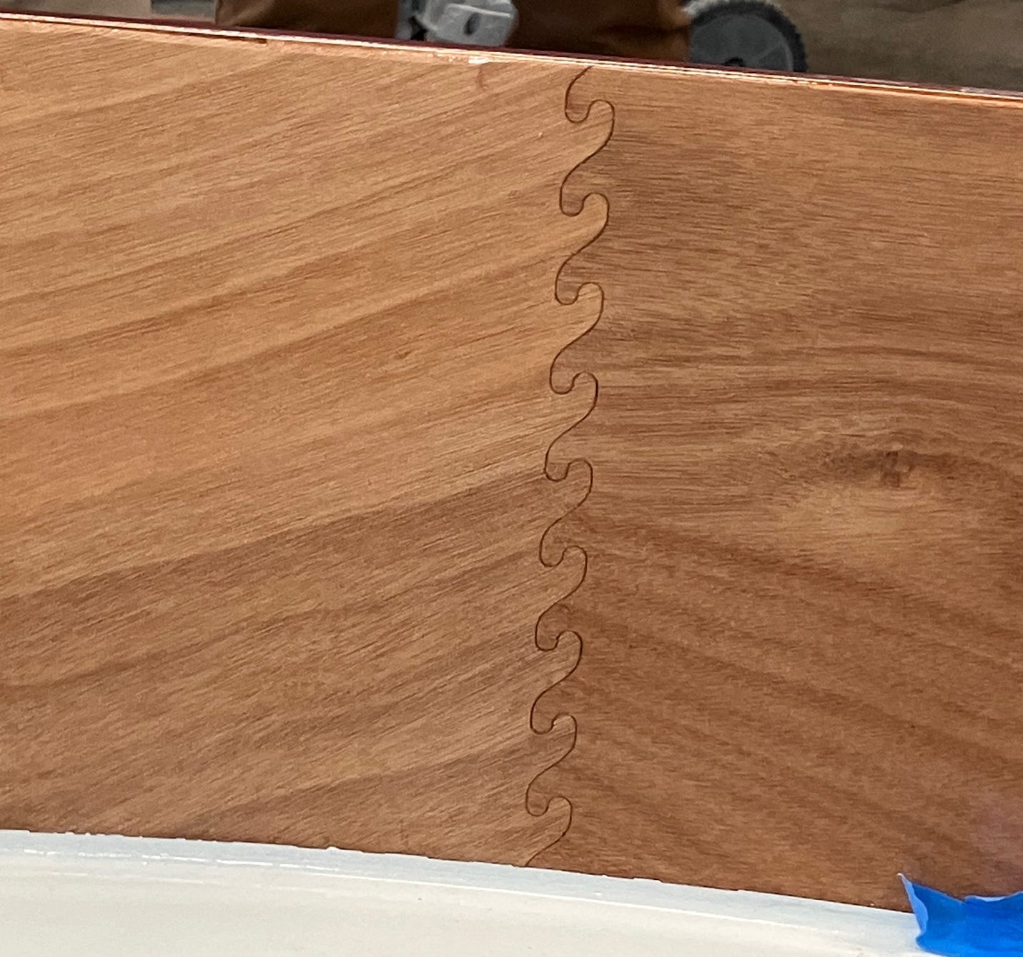 A wood board with a blue tape

AI-generated content may be incorrect.