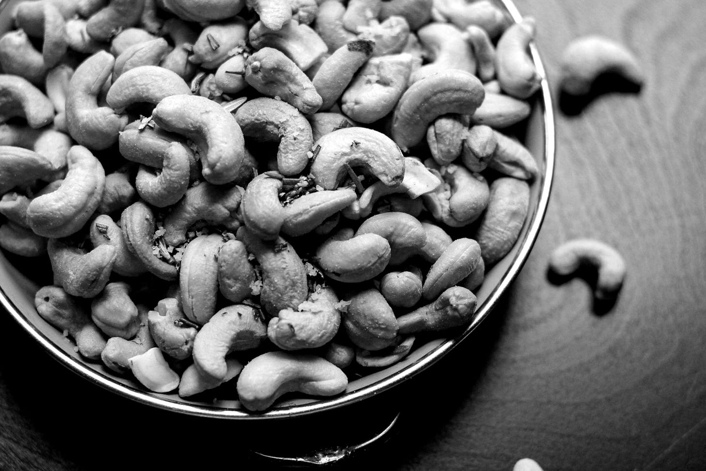 cashew nut lot on blue ceramic bowl cashew nut lot on blue ceramic bowl