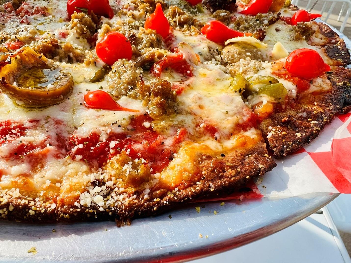 A pizza on a plate

Description automatically generated