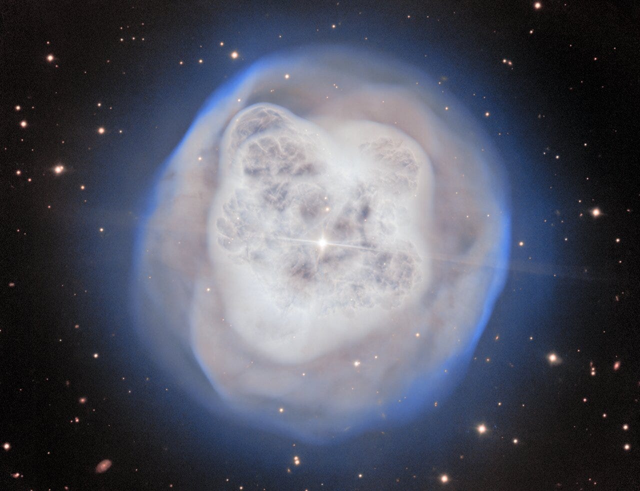 A white nebula over a black background with a
bright star in the center. A white nebula over a black background with a
bright star in the center.