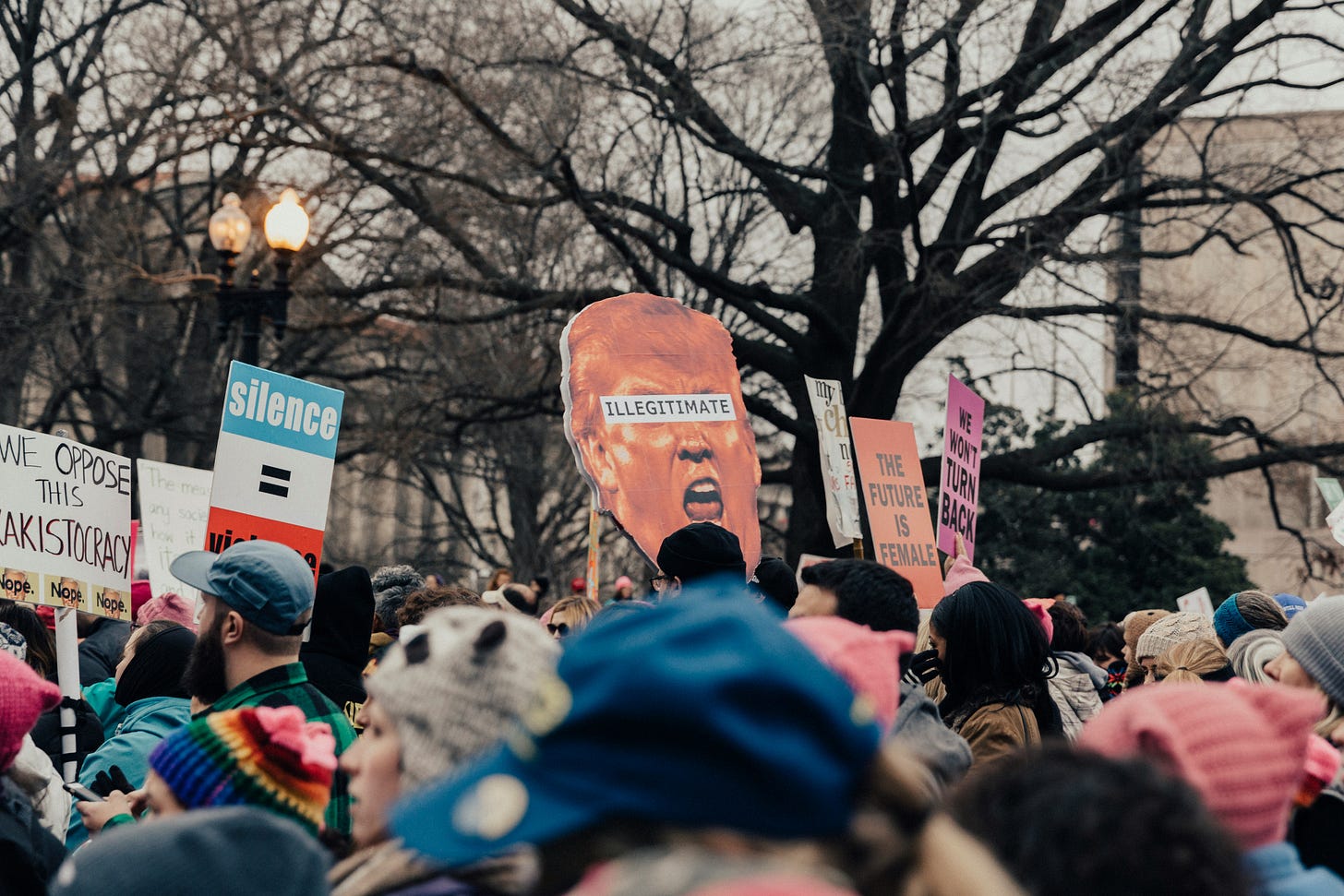 People in a protest march holding signs People in a protest march holding signs
