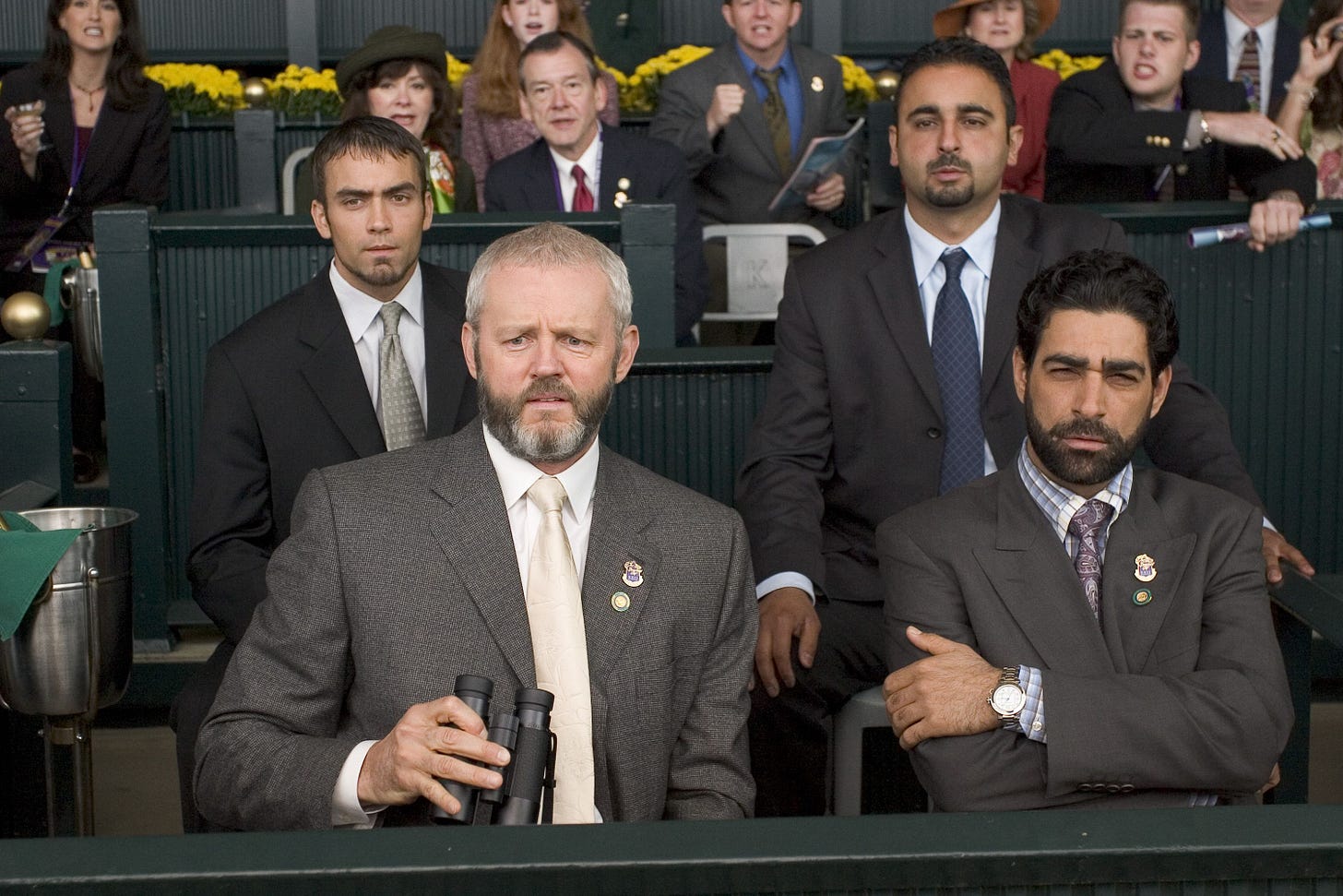 Morse looking on in some kind of distaste from the stands of a horse race in Dreamer (2005)