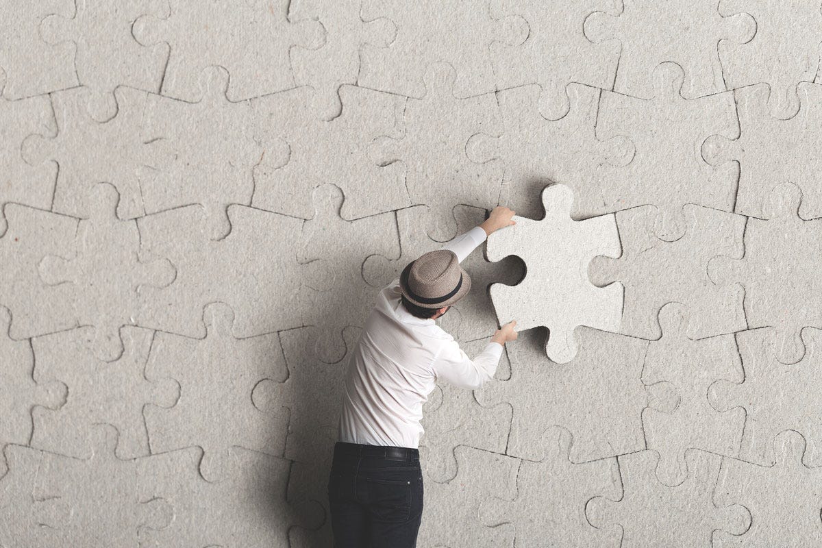 Man Completing a Wall Puzzle