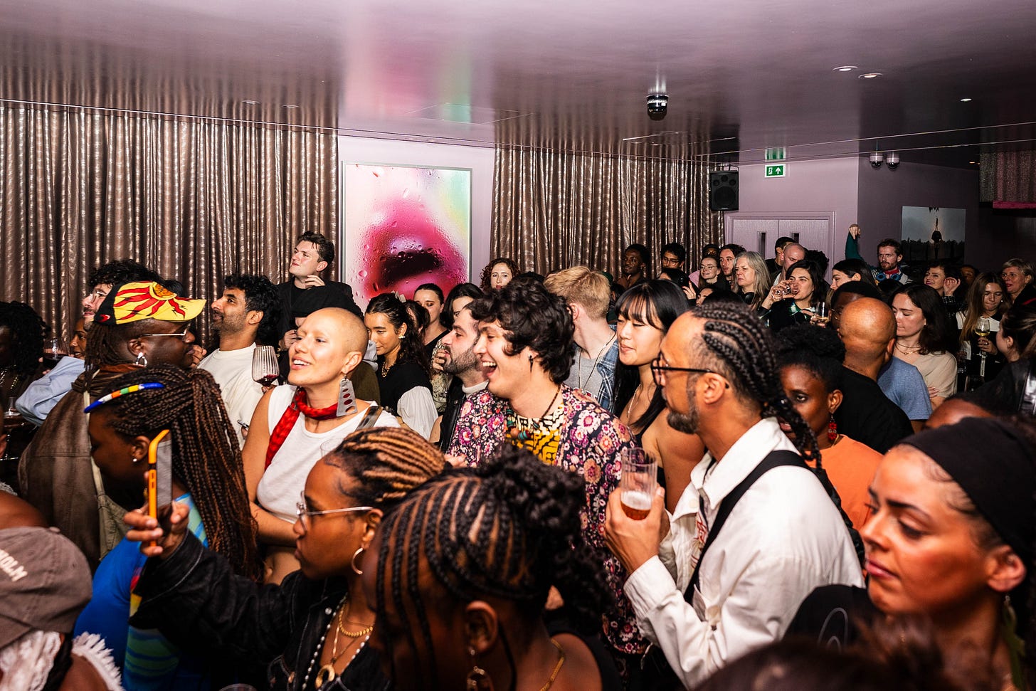 Dense crowd of visitors gathered inside a hotel space during Minor Attractions, highlighting the fair’s social, open-access energy.