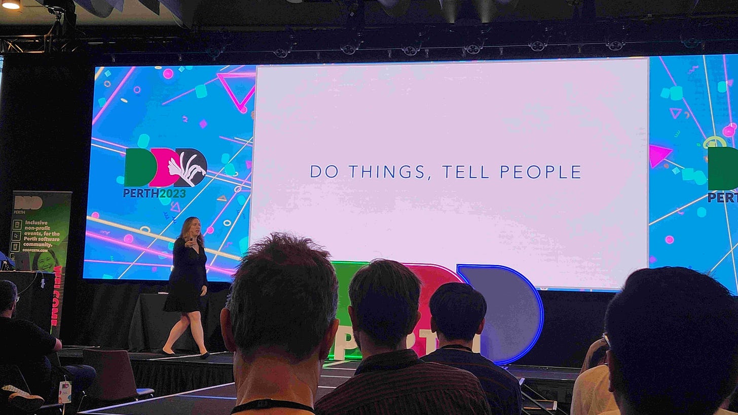 Photo of a woman stood on stage presenting