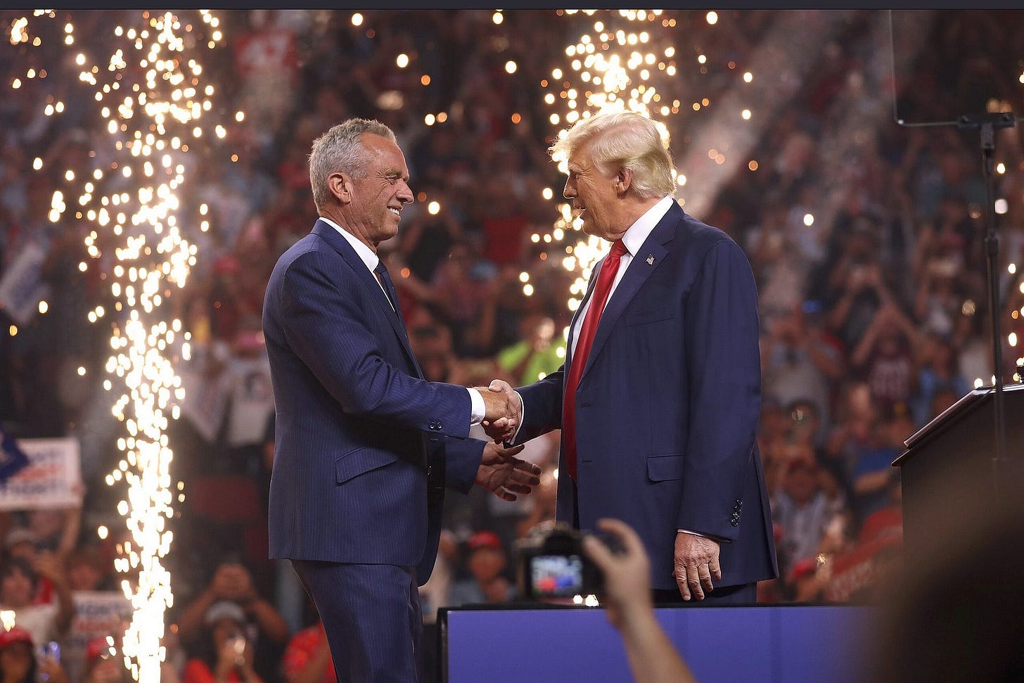 Robert F. Kennedy, Jr. shaking hands with Donald Trump after endorsing Trump at a rally in Arizona on August 23, 2024