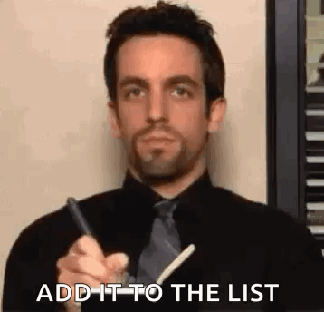 a man in a black shirt and tie is writing on a piece of paper . a man in a black shirt and tie is writing on a piece of paper .