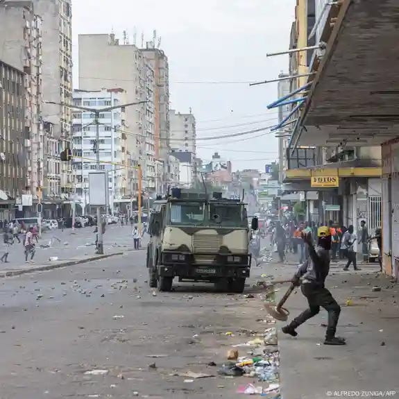 A protester throws a stone toward an armored vehicle as protesters clash with Mozambican riot police in Maputo on November 27, 2024 A protester throws a stone toward an armored vehicle as protesters clash with Mozambican riot police in Maputo on November 27, 2024