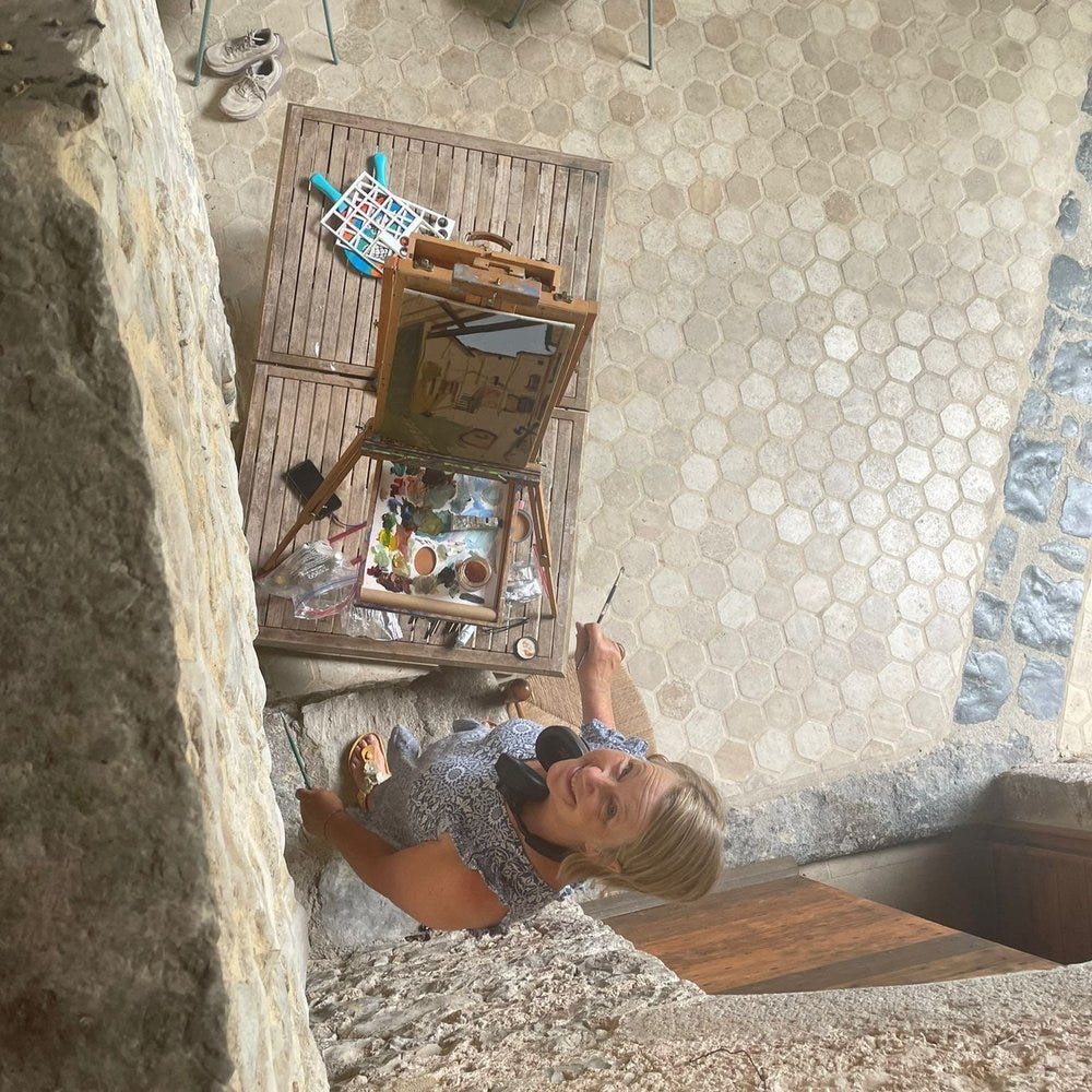 Balanced on a table to paint the courtyard