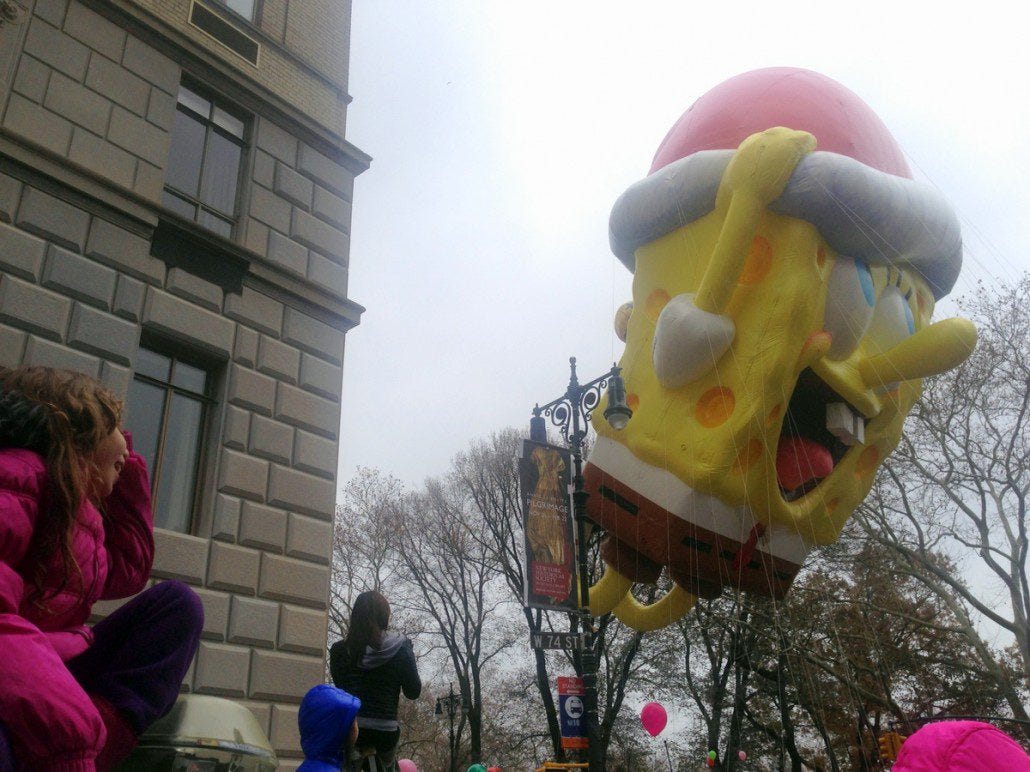 A little girl watches in delight as Sponge Bob Square Pants floats on by.
