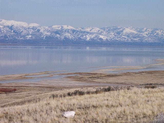 Snow-covered mountains reflect off of the Great Salt Lake. Snow-covered mountains reflect off of the Great Salt Lake.
