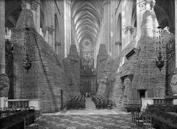 This may contain: an old black and white photo of the inside of a church with pews in it