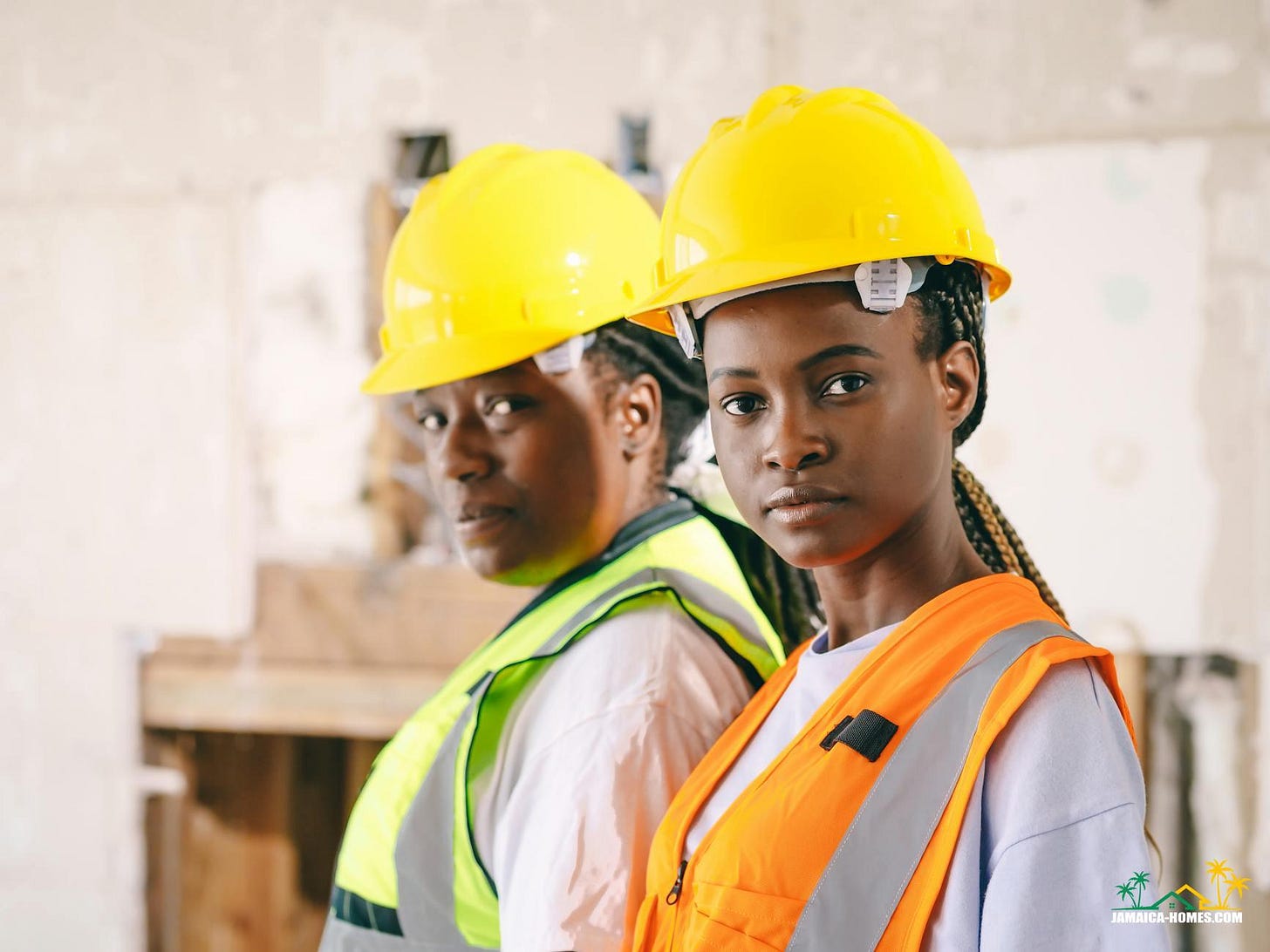 women in yellow hardhat and reflective vest