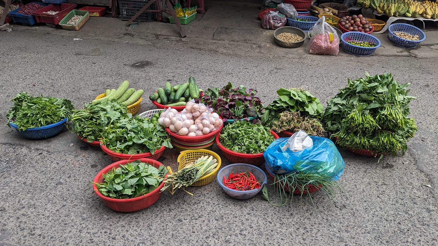 vendor baskets of vegetables in the street