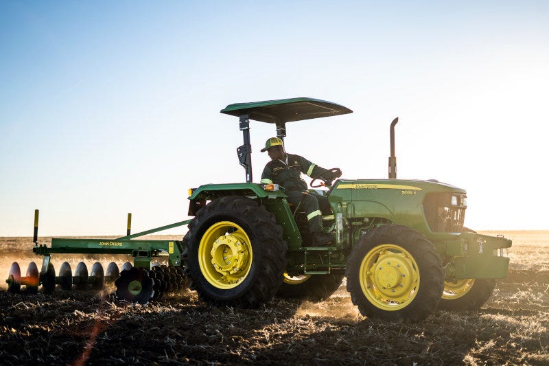 A John Deere tractor in the field. A John Deere tractor in the field.