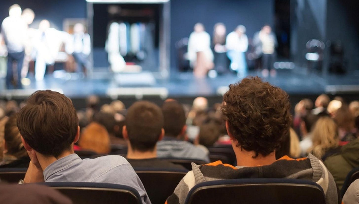 An audience watching a play
