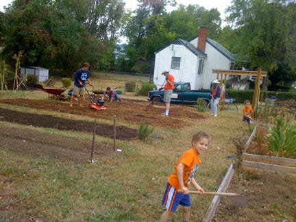 Diverse families--African American, Burmese. Latina, and white--in a Charlottesville, VA, community garden.