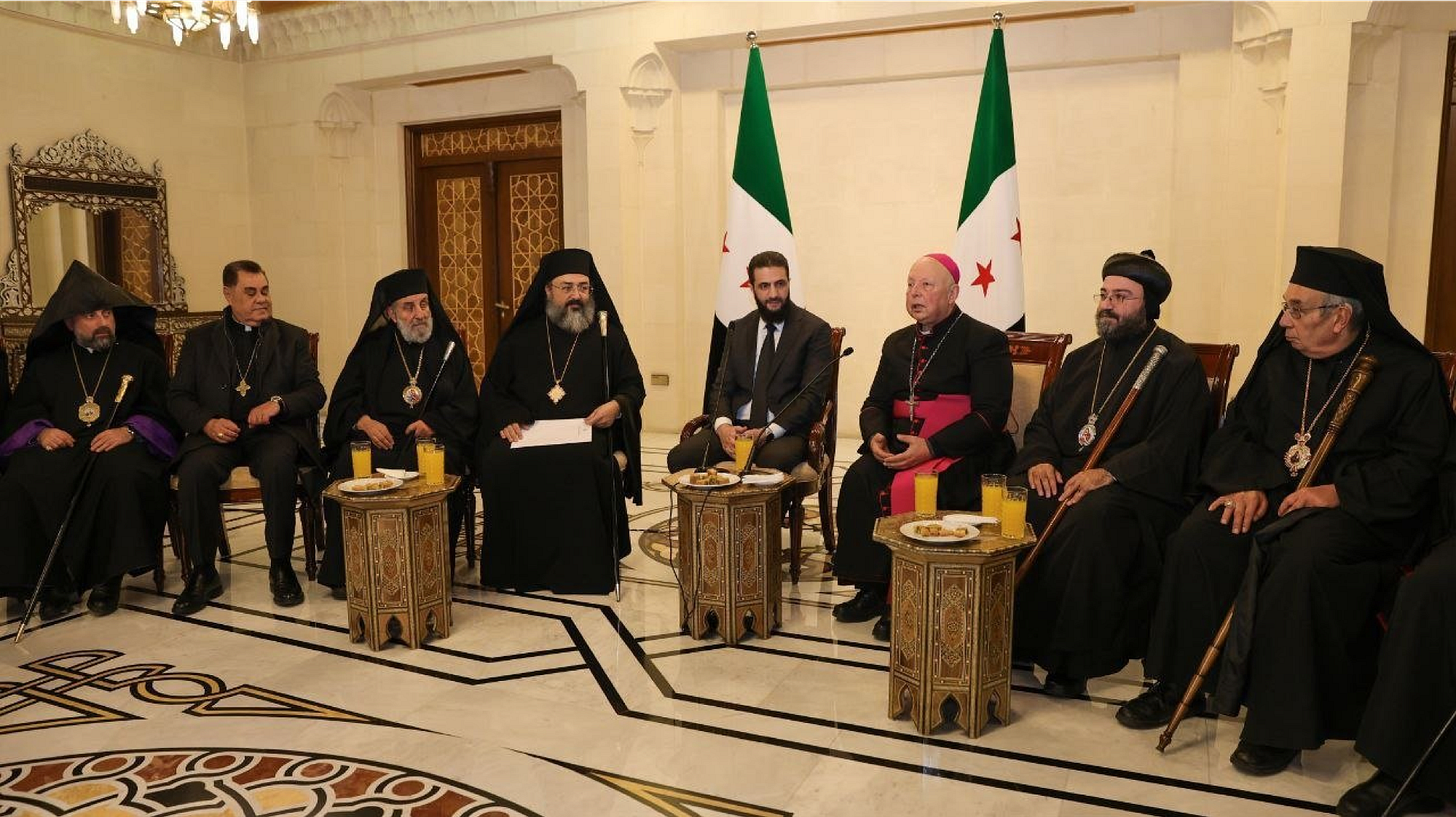 Ahmed al-Sharaa, the leader of Syria's new administration, holds a meeting with the Christian community in Damascus, Dec. 31, 2024. (SANA Handout)