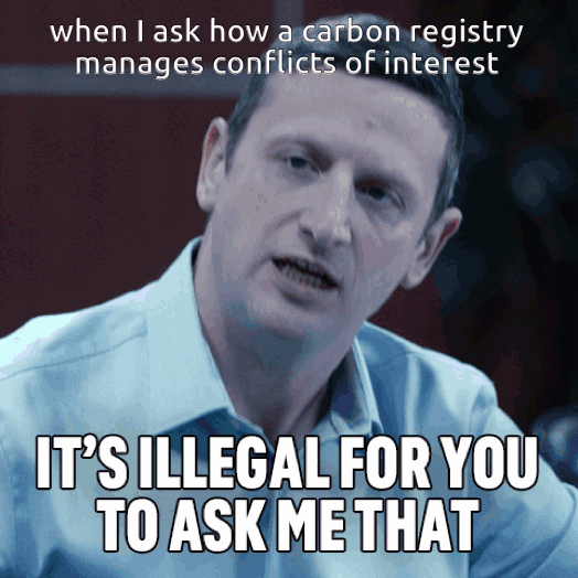Animated GIF captioned "when I ask how a carbon registry manages conflicts of interest". A man in a light blue shirt leans toward the camera with a pained, defensive grimace, with the caption "IT'S ILLEGAL FOR YOU TO ASK ME THAT".