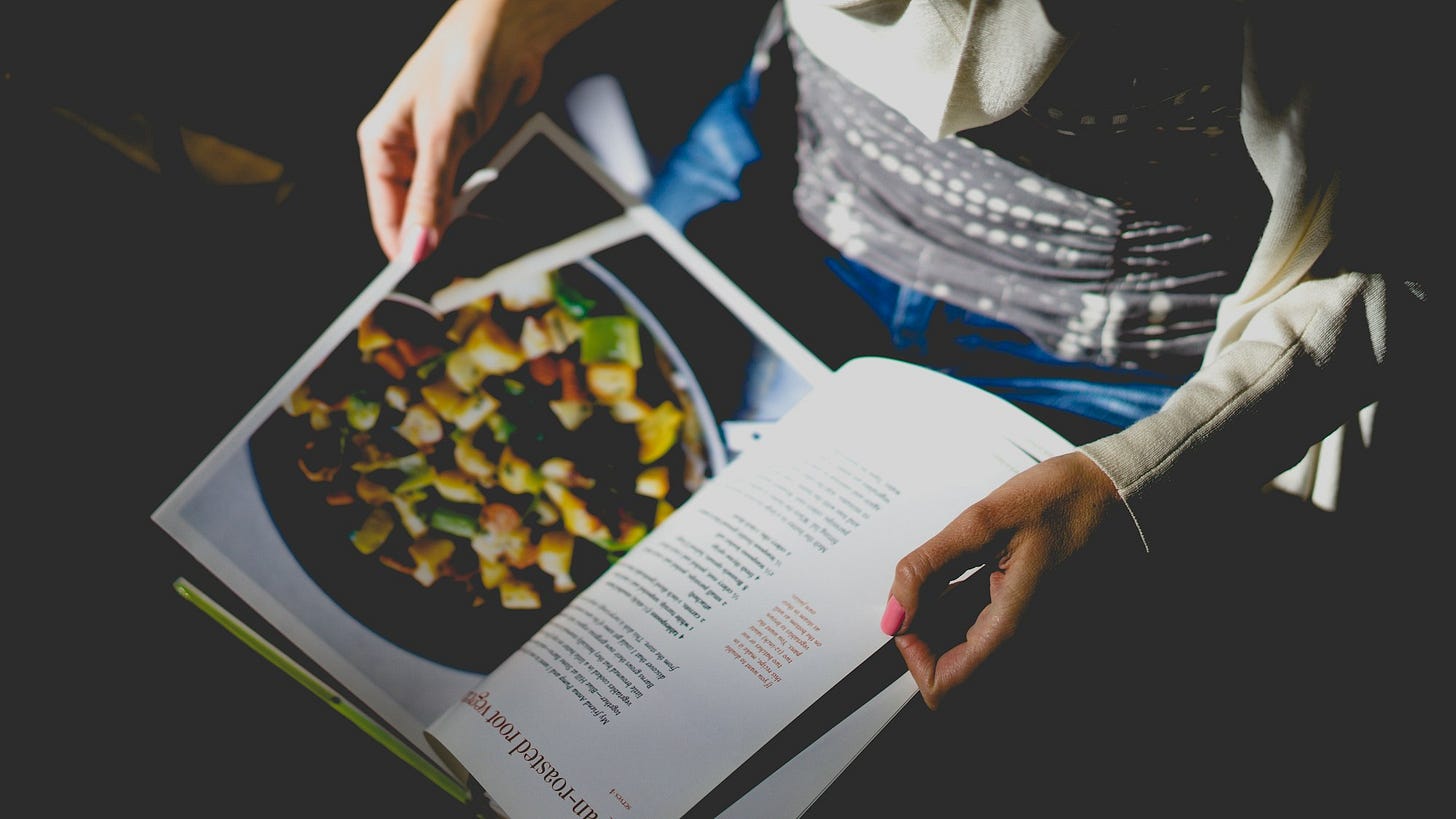 person looking at cookbook