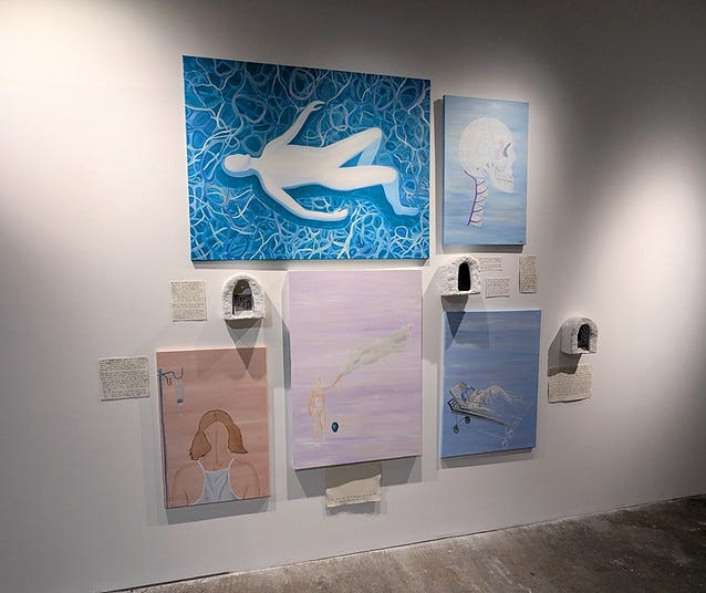 An installation of paintings, shrines and letters in an exhibition.