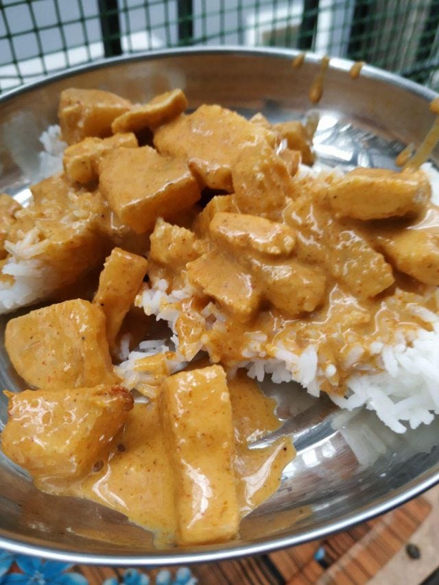 A plate with white rice and yellow-orange gracy with chunks of pineapple. A plate with white rice and yellow-orange gracy with chunks of pineapple.