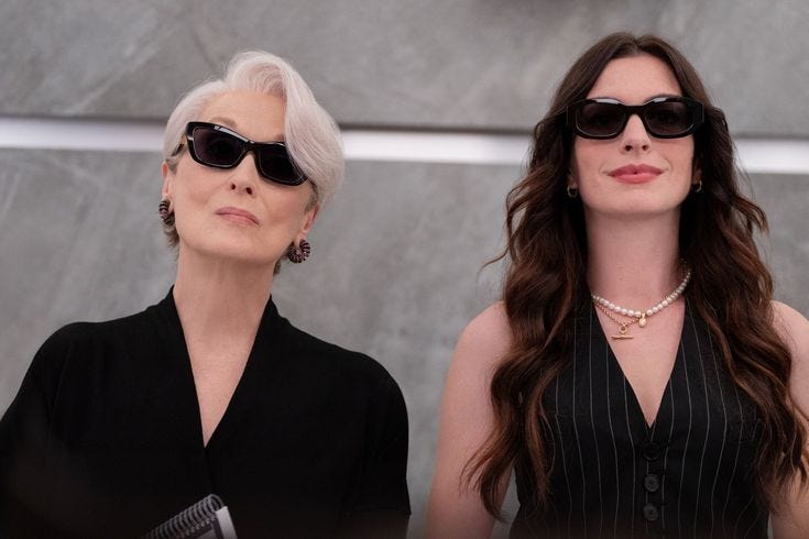 This may contain: two women wearing sunglasses are standing next to each other
