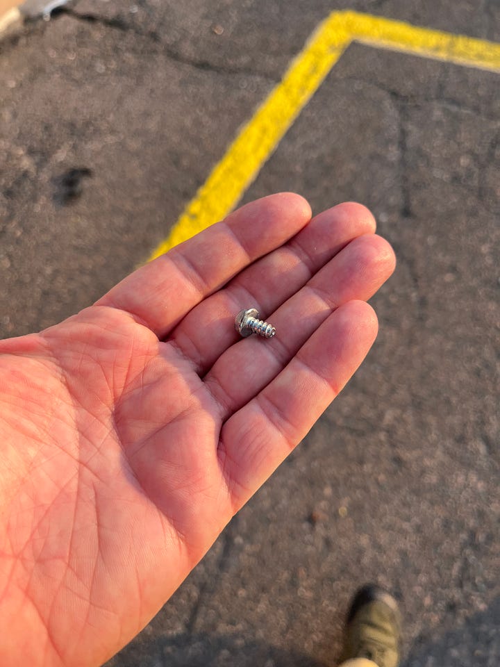 four images of things I've picked up off the ground in my walking. The first three are various screws and naisl. The last is an odd, heavy bit of round metal that appears to be a part from a car.