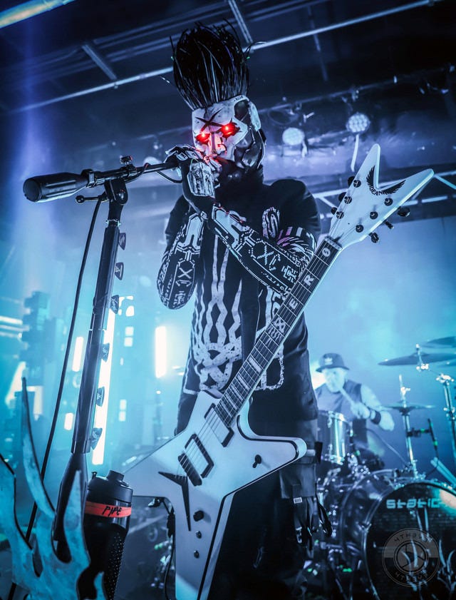 A man in a mask sings into a microphone A man in a mask sings into a microphone