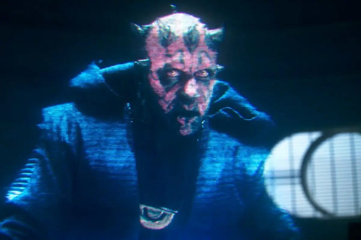 Maul, wearing the medallion of the Crimson Dawn crime syndicate, addresses Qi'ra via hologram in 'Solo: A Star Wars Story.'