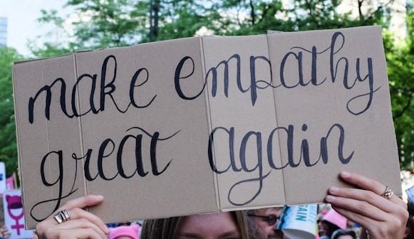 a man and woman holding a sign