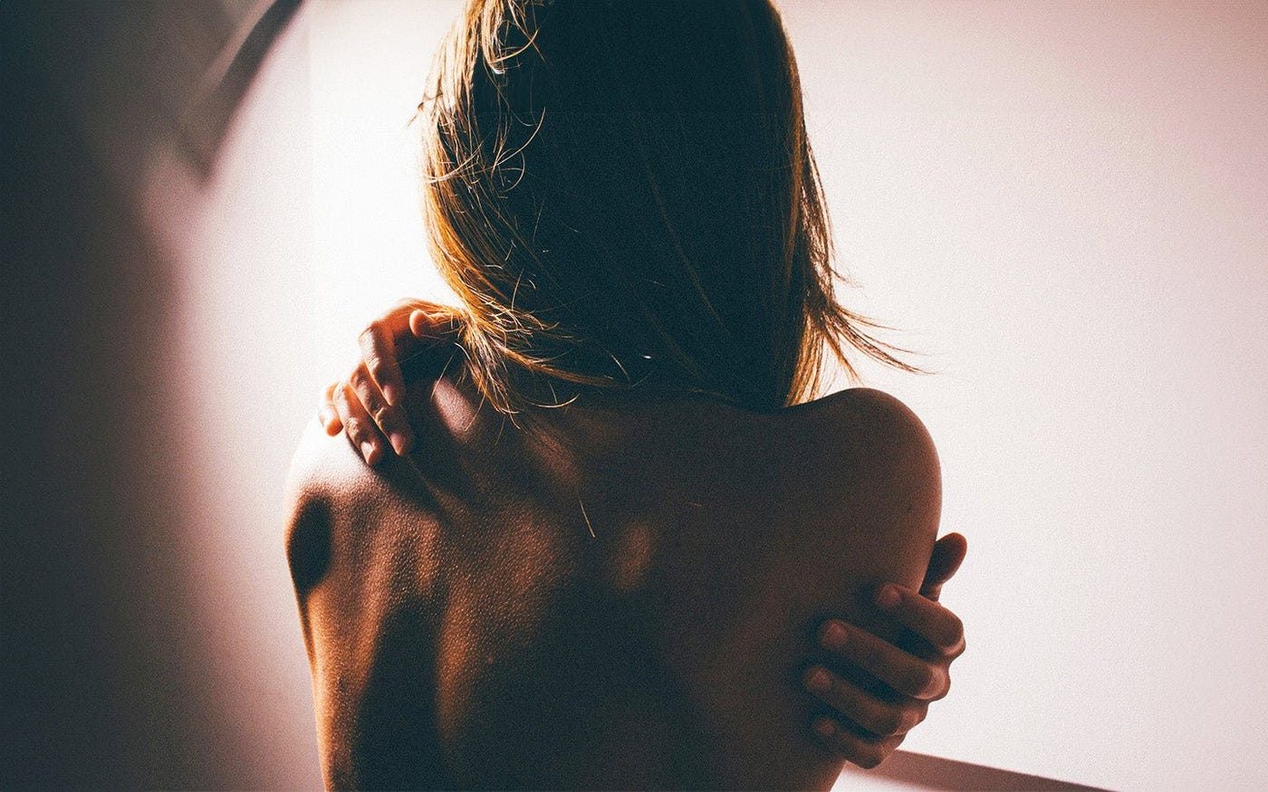 A woman hugging herself A woman hugging herself