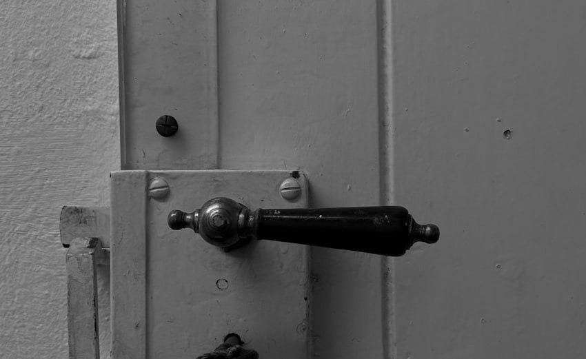 Close-up of an old door handle and lock with key.