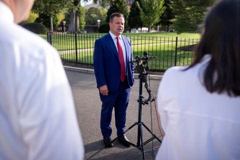 a man speaks into a microphone outside a man speaks into a microphone outside