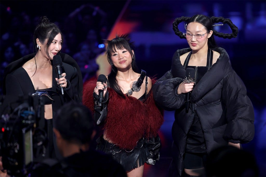 ELMONT, NEW YORK - SEPTEMBER 07: (L-R) EJAE, REI AMI and Audrey Nuna of HUNTR/X from ‘KPop Demon Hunters’ speak onstage during the 2025 MTV Video Music Awards at UBS Arena on September 07, 2025 in Elmont, New York. (Photo by Manny Carabel/Getty Images for MTV)