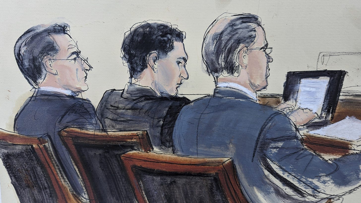 Samuel Bankman Fried flanked by his defense attorneys during his fraud trial.