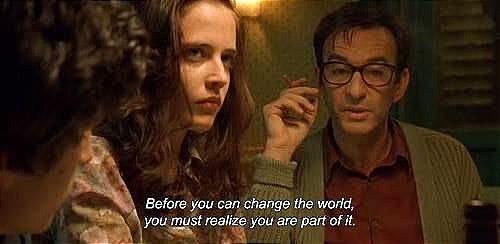 This may contain: a man and woman sitting next to each other in front of a mirror with the words before you can change the world, you must