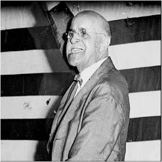 A person in a suit smiling

Description automatically generated with low confidence