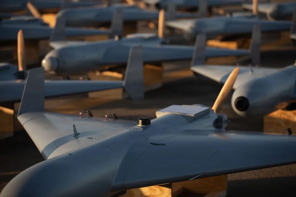 Low-cost Unmanned Combat Attack System (LUCAS) drones are positioned on the tarmac at a base in the U.S. Central Command (CENTCOM) operating area, Nov. 23.
