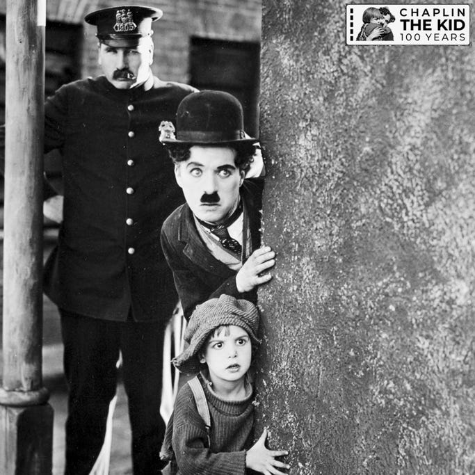 A person and child looking out from a wall

Description automatically generated