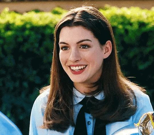 This may contain: a woman wearing a tie and smiling at the camera