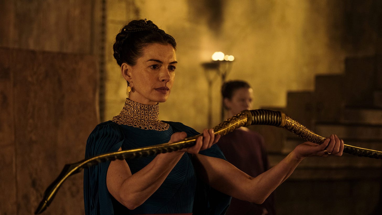 The Odyssey | Still features Anne Hathaway as Penelope holding Odysseus's bow.