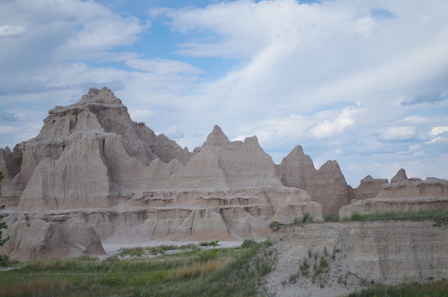 Sharply peaked hills of pink and dusty sand at Badlands National Park in South Dakota 