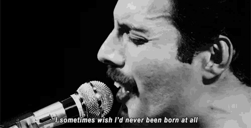 a man singing into a microphone with the words " sometimes wish i 'd never been born at all " a man singing into a microphone with the words " sometimes wish i 'd never been born at all "