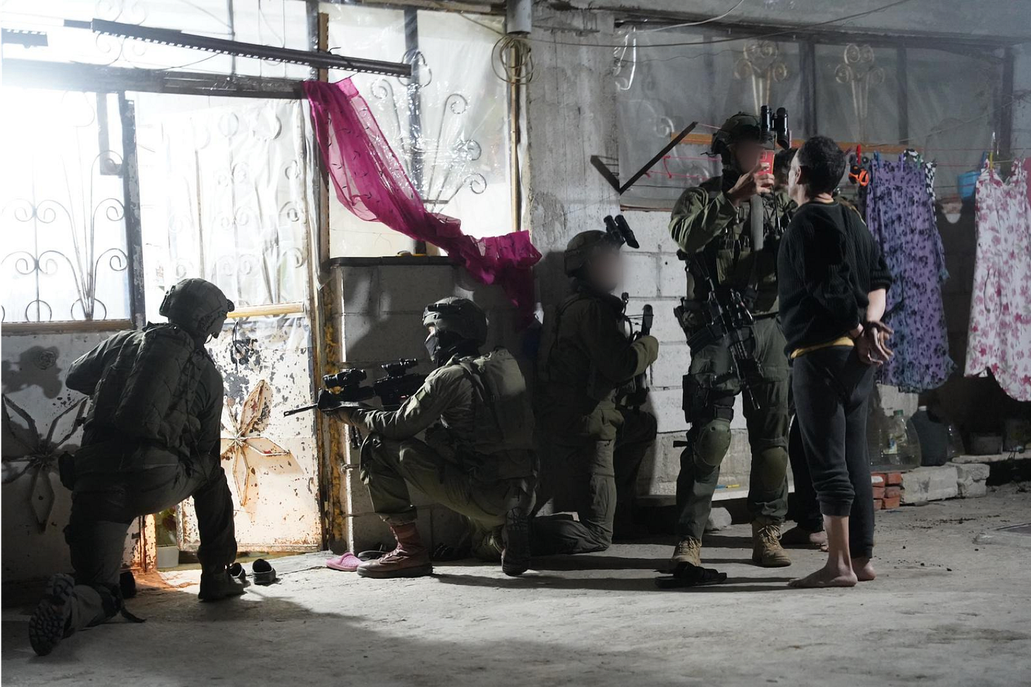 The IDF’s own released photo from the morning of the attack, showing an Israeli soldier interrogating a Syrian man.