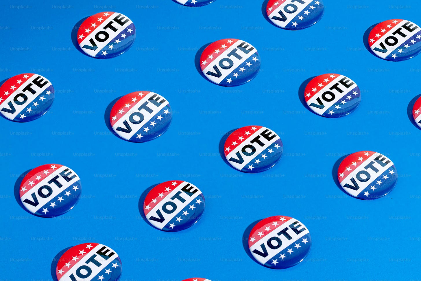 a group of political buttons on a blue background