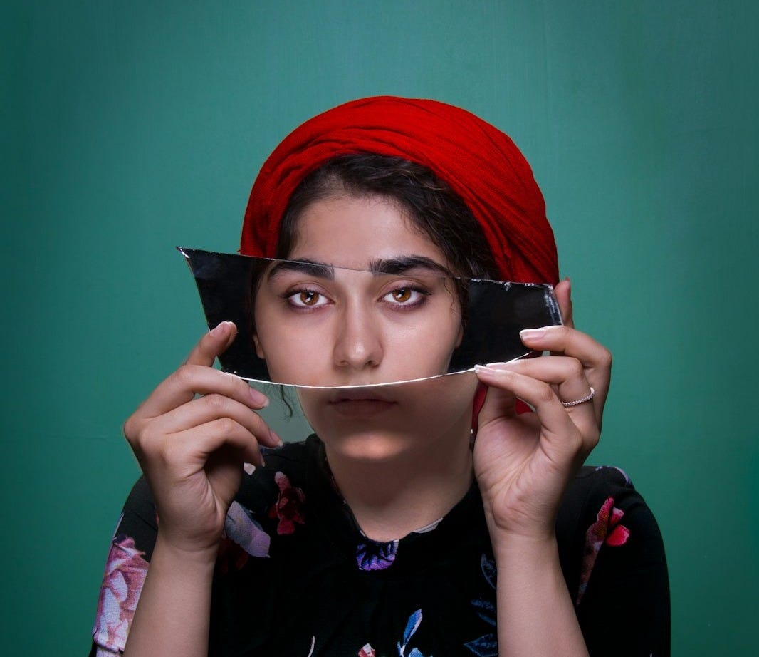 woman holding mirror shard